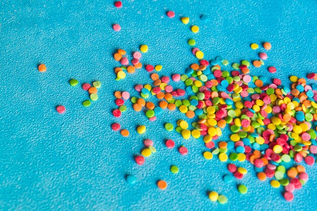 Background of colorful candies. rainbow topping for topping ice
cream and cakes. top view.