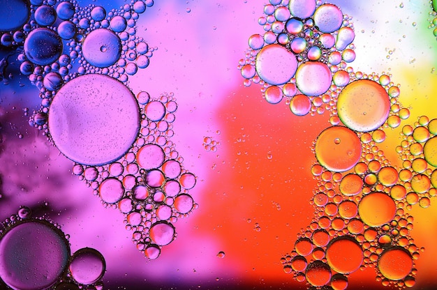 Background of colorful oil drops in water surface - abstraction