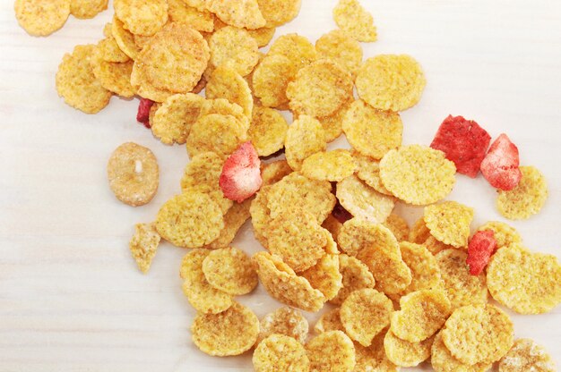 Background of corn flakes with slices of strawberries