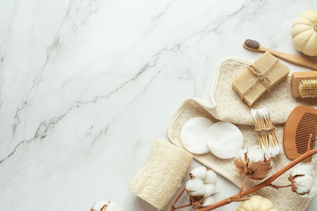 Background for cosmetics Natural eco cosmetics on a gray background A wooden brush with a cotton towel and natural soap