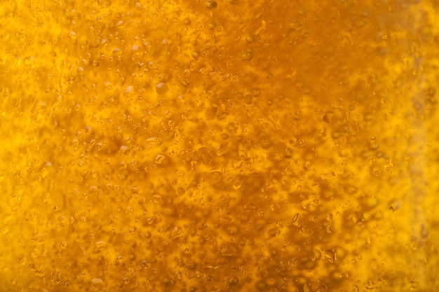 A background created from a closeup of cold light beer in a glass