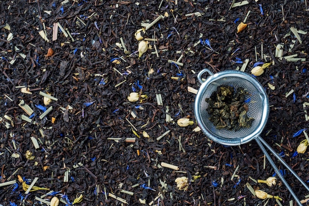 Background of dry tea leaves and flowers.