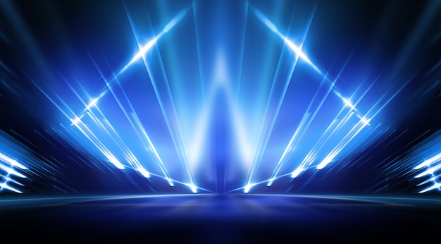 Background of empty stage show. Neon light and laser show. Laser futuristic shapes on a dark background. Blue neon light, symmetrical reflection.