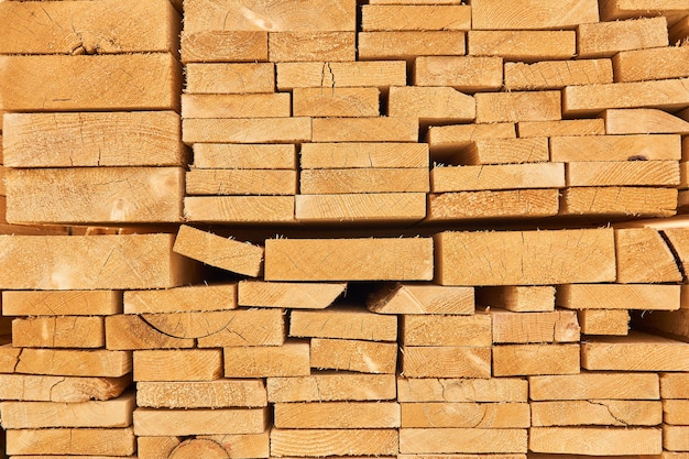 background - ends of stacked freshly made boards of various sizes