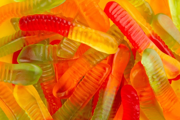 Background filled with heap of colorful gummy worms