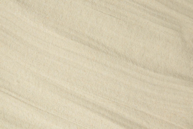 A background of fine quartz sand laid with soft waves Template