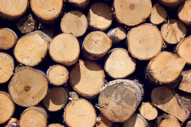 Background of firewood stacked in the woodpile. 