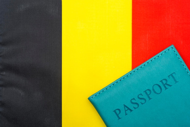 On the background of the flag of Belgium is a passport