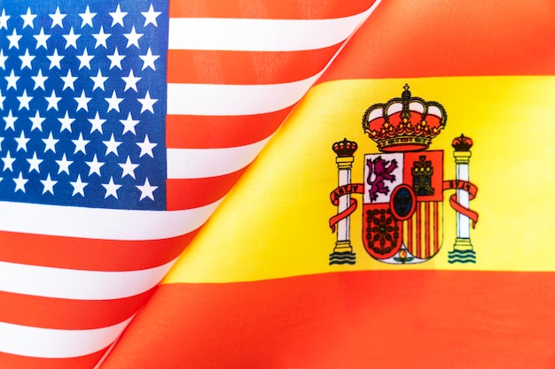 Background of the flags of the usa and spain the concept of\
interaction or counteraction between two countries international\
relations political negotiations sports competition