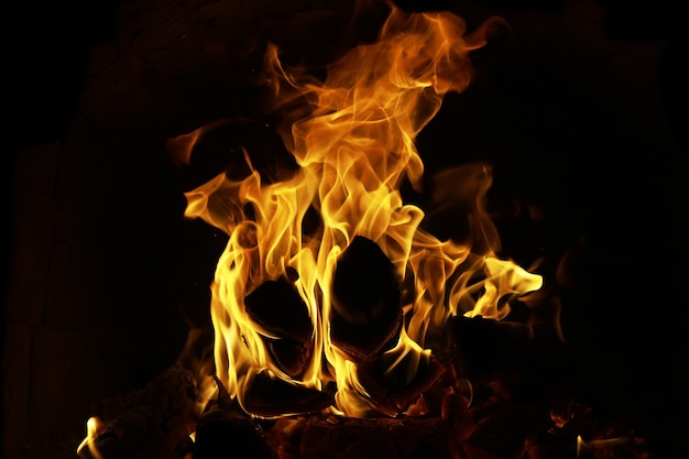 Background of the flame in the oven Tongues of fire in a brick fireplace Fire texture