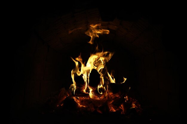 Background of the flame in the oven Tongues of fire in a brick fireplace Fire texture