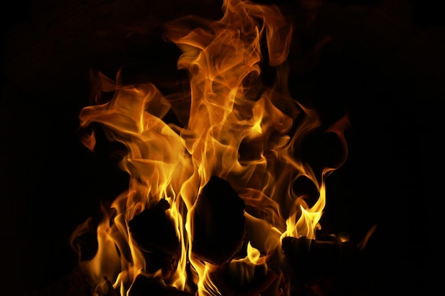 Background of the flame in the oven Tongues of fire in a brick fireplace Fire texture