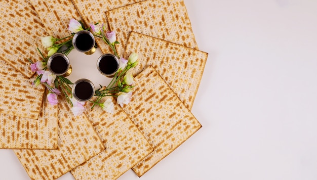 Background of four wine cups with matzah