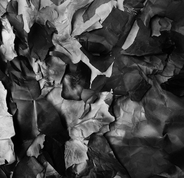 Background of fragments of crumpled paper black and white