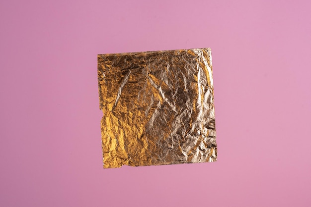 background frame from a piece of gold leaf on pink paper