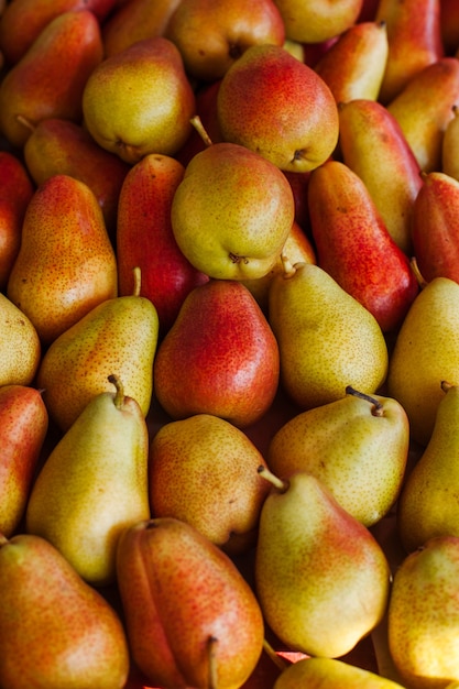 Background of freshly harvested ripe organic pears on sale at a farmers market