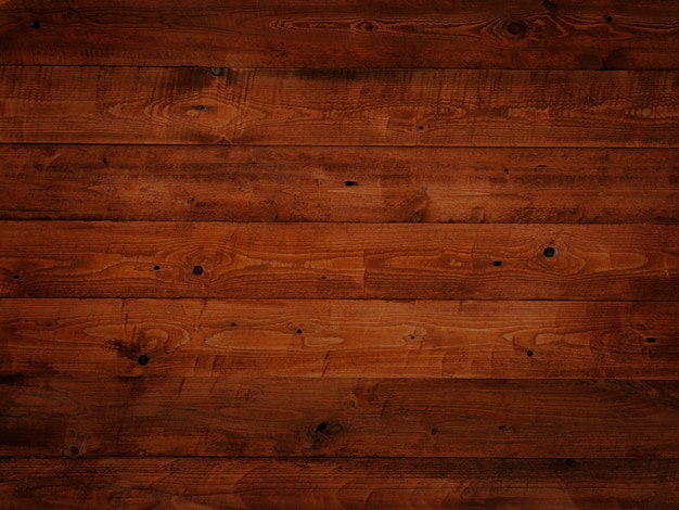 Background from boards painted with brown dark orange paint, old vintage, wood texture in knots, boards horizontally