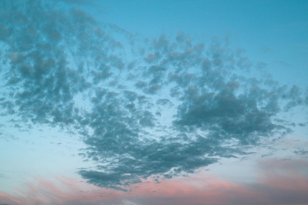 Background from the clouds at sunset or dawn with space for text. Blue clouds in sunset.