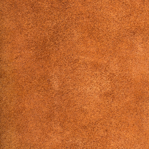 Background from dark orange suede close up