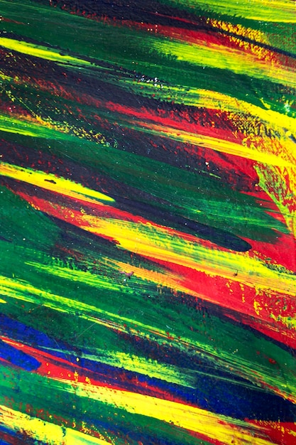 Background from different strokes of red yellow green and blue\
paint with brush closeup bright color