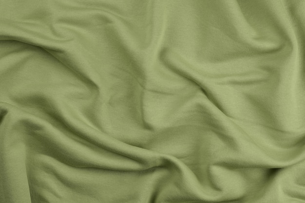 Background from green monochrome cotton fabric close up texture