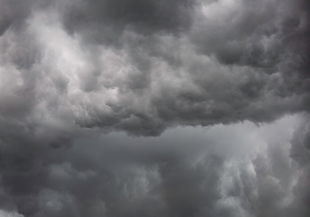 Background from moody sky and dark black storm clouds. surface texture thunderstorm sky