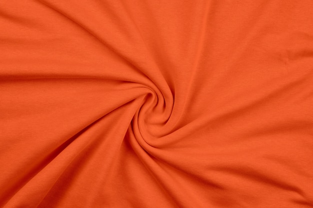 Background from orange monochrome cotton fabric close up texture