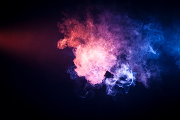 Background from pink and  blue  smoke of vape on black isolated