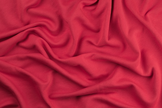 Background from red monochrome cotton fabric close up texture