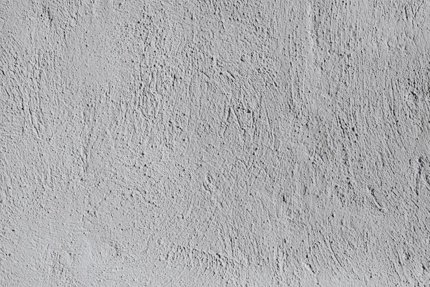 Background from a seamless pattern of gray stone wall covered with decorative plaster.