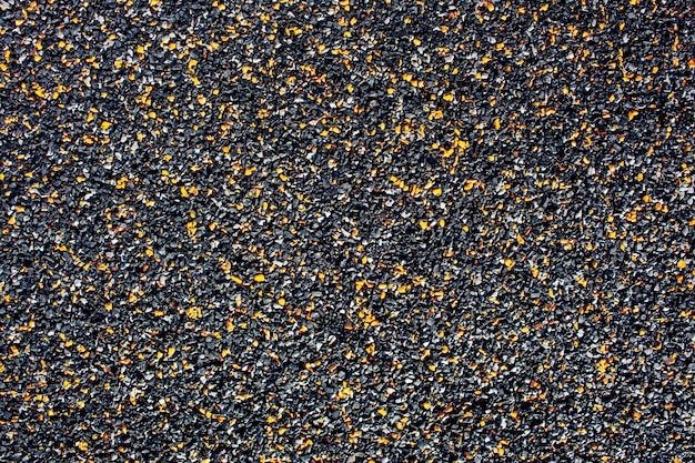 Background from small stone chips of black and orange colors