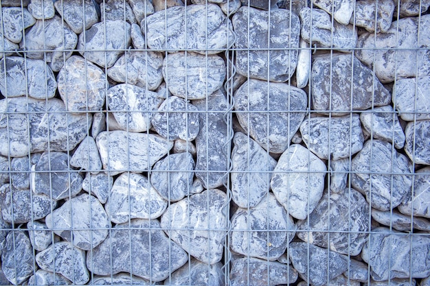 Background from stones stacked into a wall. Border decorated with gray stones.