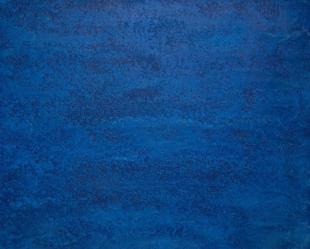 Background from a textured plaster of bright blue color. art background