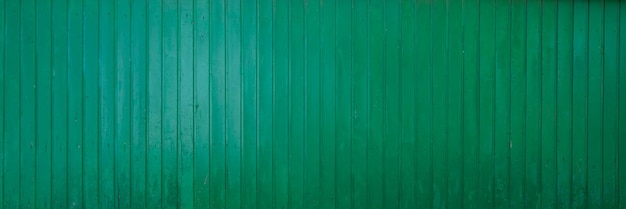 Background green classic wooden fence planks texture in wood wallpaper in panoramic web format and header