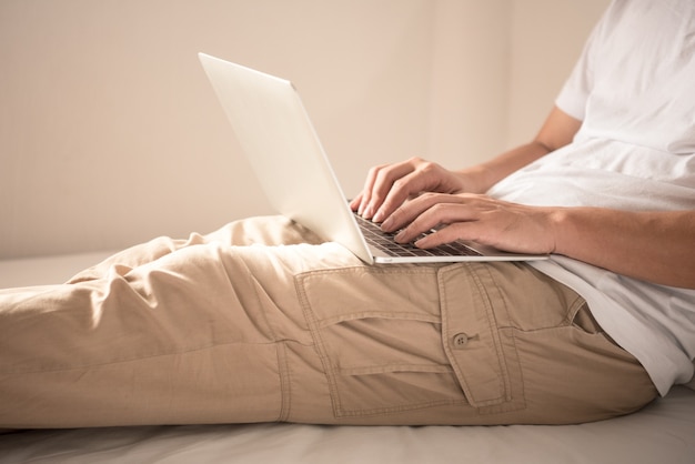 background of hand is typing on keyboard computer.