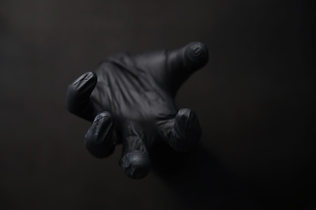 Background of hands in gloves Black gloves Hand gestures in black gloves