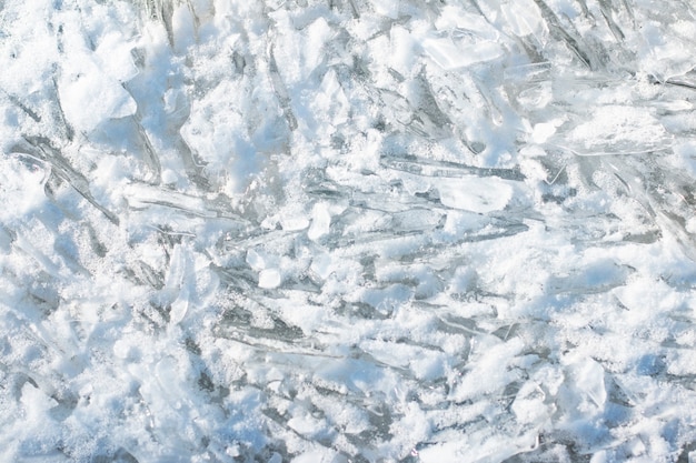 Background Ice floe breaking up against shore glittering ice crystals on the surface of the river