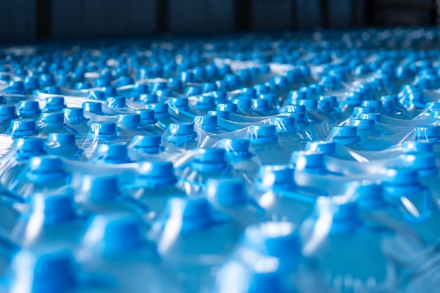 Photo background image of blue plastic bottles with blue cap and handle in packaging