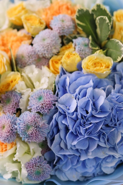 Background image of bouquet of flowers closeup Blue hydrangea yellow roses unusual chrysanthemum