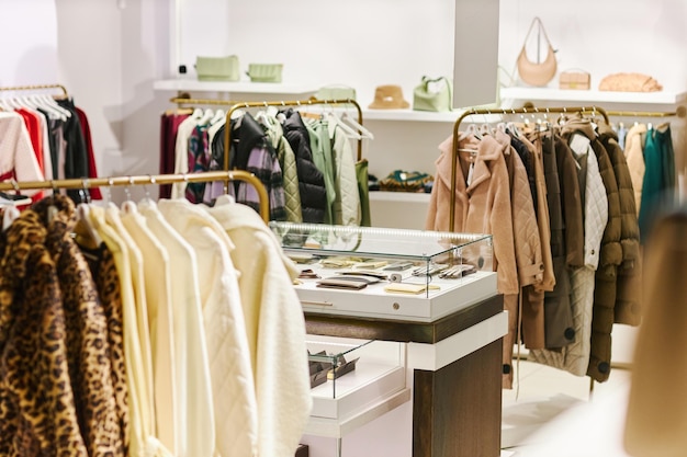 Background image of boutique interior shopping mall with clothes on hangers