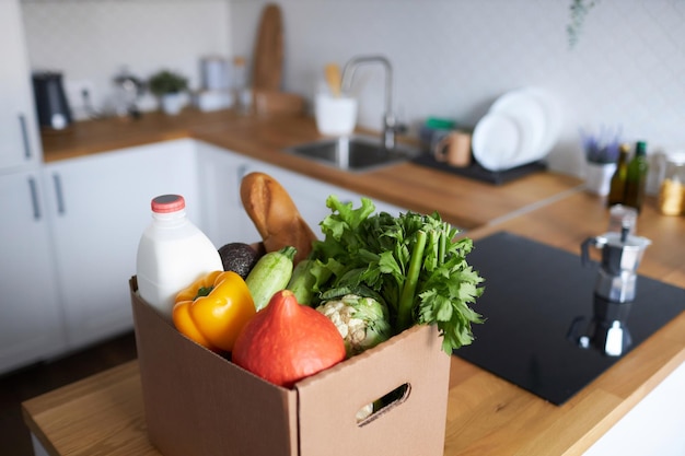 background image of box with fresh groceries in kitchen