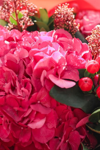 Background image of a bright bouquet of flowers Pink hydrangea closeup hypericum and skimia