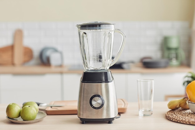 Background image of chrome blender on kitchen counter with fruits copy space