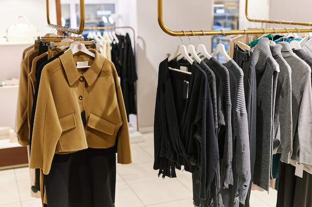 Background image of clothing racks with Autumn fashion collection in boutique