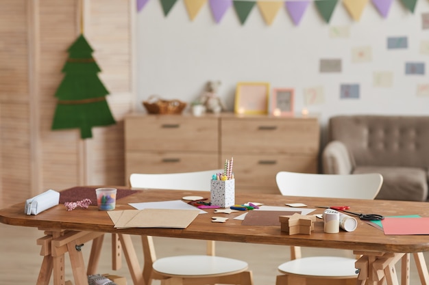 Background image of crafting table in decorated school classroom, copy space