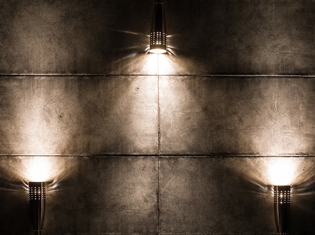 Background image of a dark wall with three lamps above