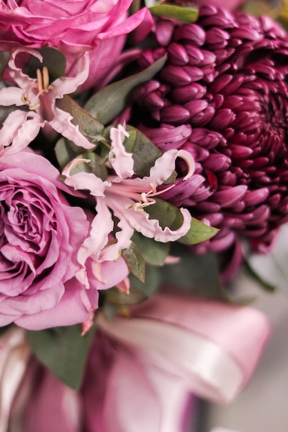 Background image of a delicate bouquet of flowers closeup in violetpink shades