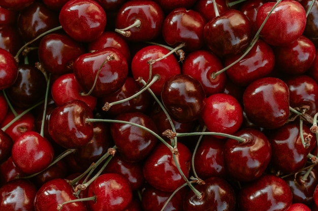 Background image of lying red ripe sweet cherries Top view flat lay Copy space