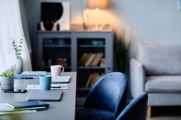 Background image of modern home interior with workplace in dark blue colors copy space