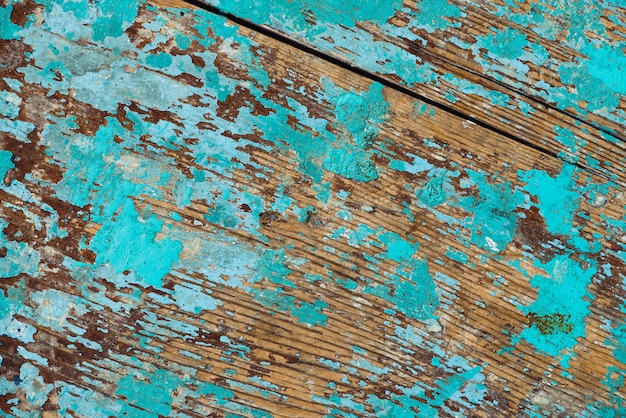 Background image of wooden surface with peeling paint. 